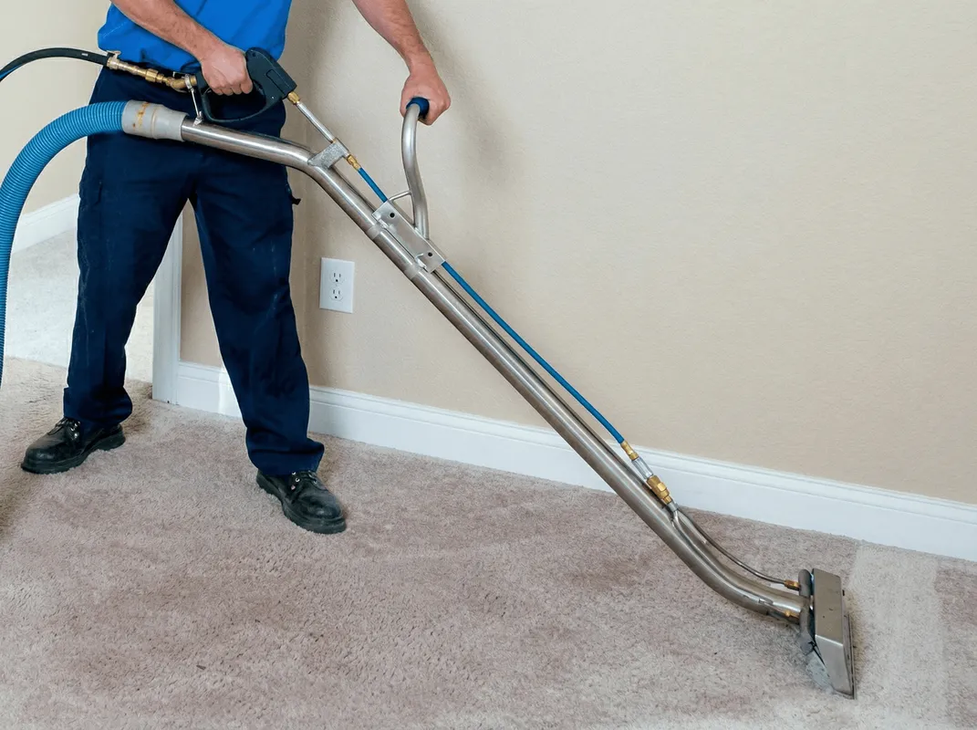 Professional operating a liquid removal machine on a carpeted floor in Salt Lake City, UT